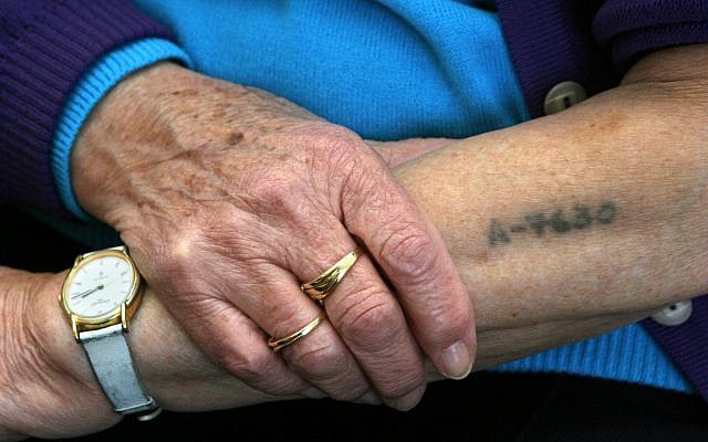 Holocaust survivor Bracha Ghilai, 75, shows her tattooed arm at her house in Holon near Tel Aviv, January 23, 2005. (AP/Ariel Schalit)